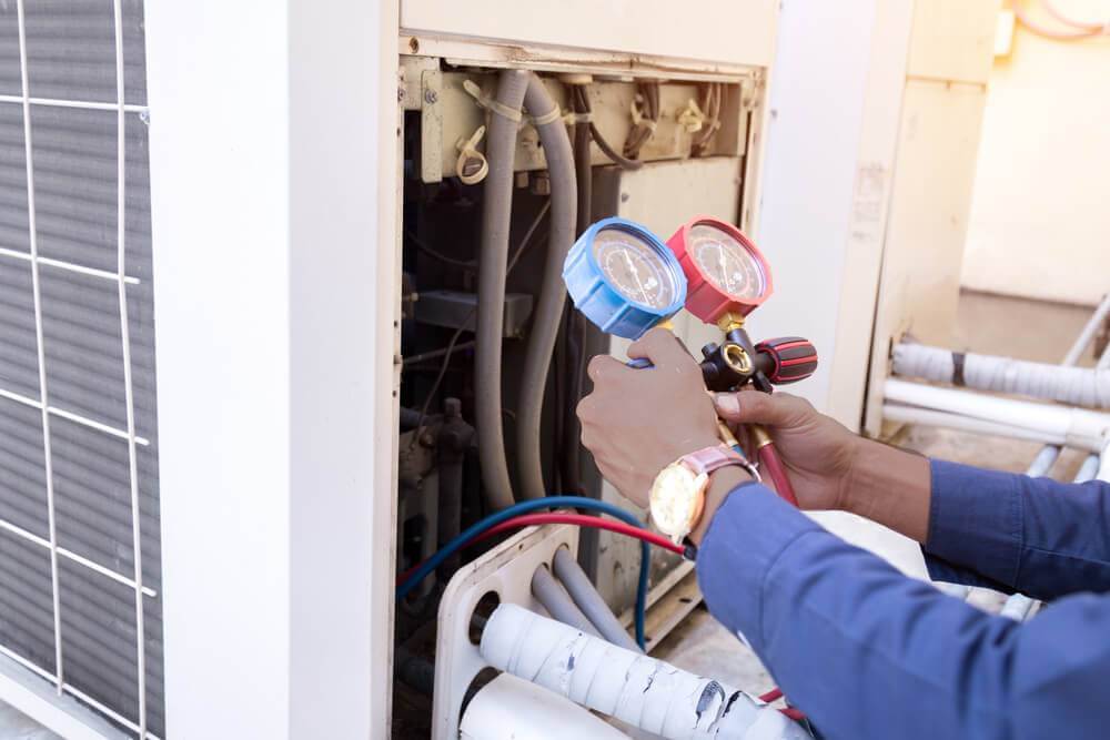 An electrician fitting a light bulb