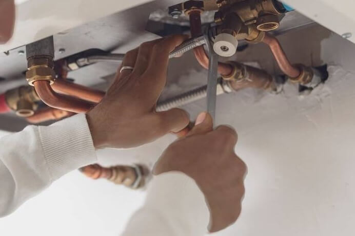 An electrician fitting a light bulb